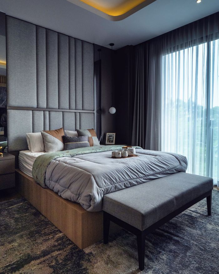 Stylish modern bedroom with elegant decor, featuring a plush bed, soft lighting, and large windows.